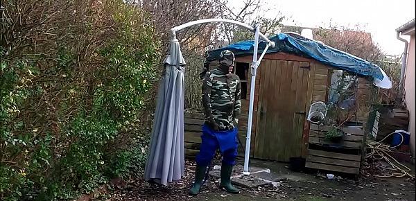  vintage - smoking guy in camo and rubber boots undressing